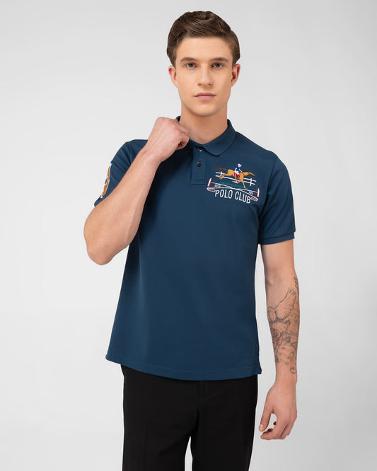 Premium teal polo shirt in mercerised cotton pique featuring signature Cantermark emblem – TENHE