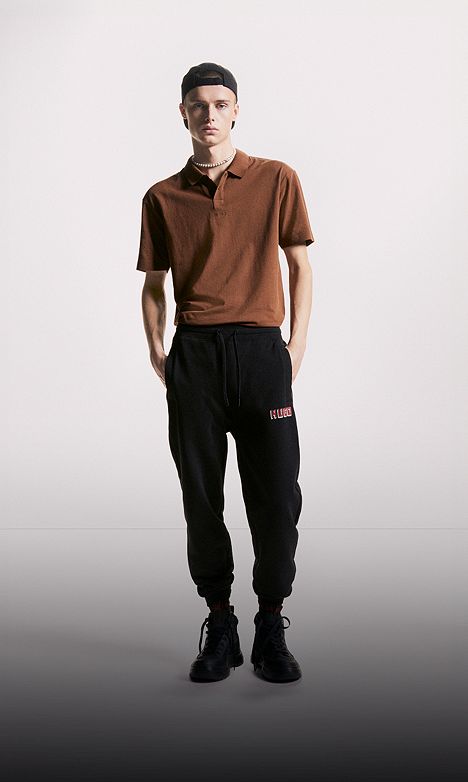 Stylish model wearing the Luxury Polo in Night Owl, featuring a smooth cotton texture and contrast collar.