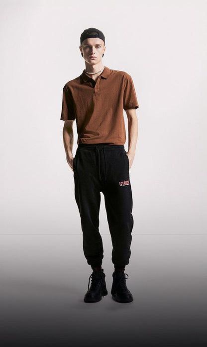 Stylish model wearing the Luxury Polo in Night Owl, featuring a smooth cotton texture and contrast collar.